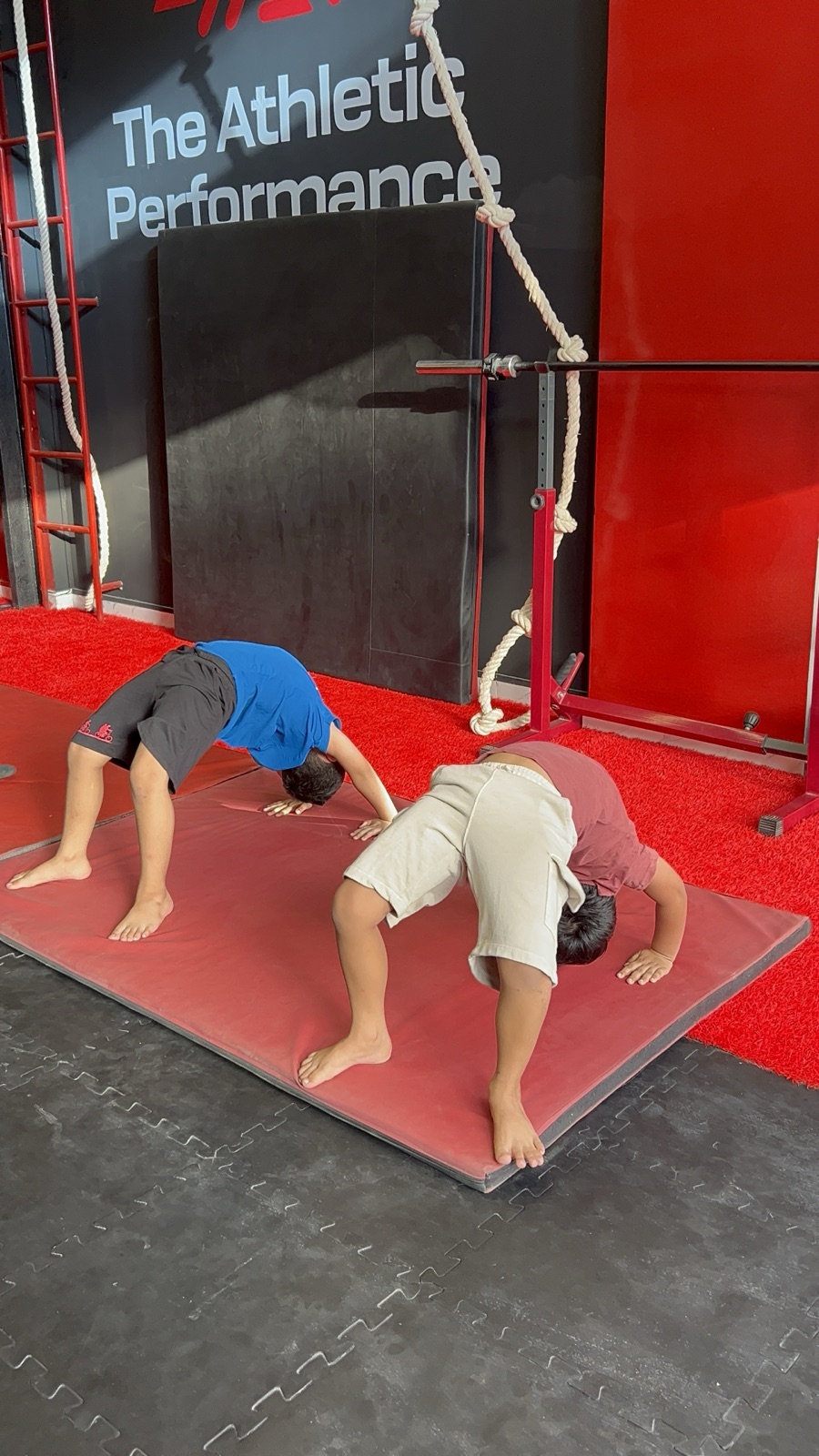 AKDP kids doing handstands with their coach at TAP DHA Phase 7