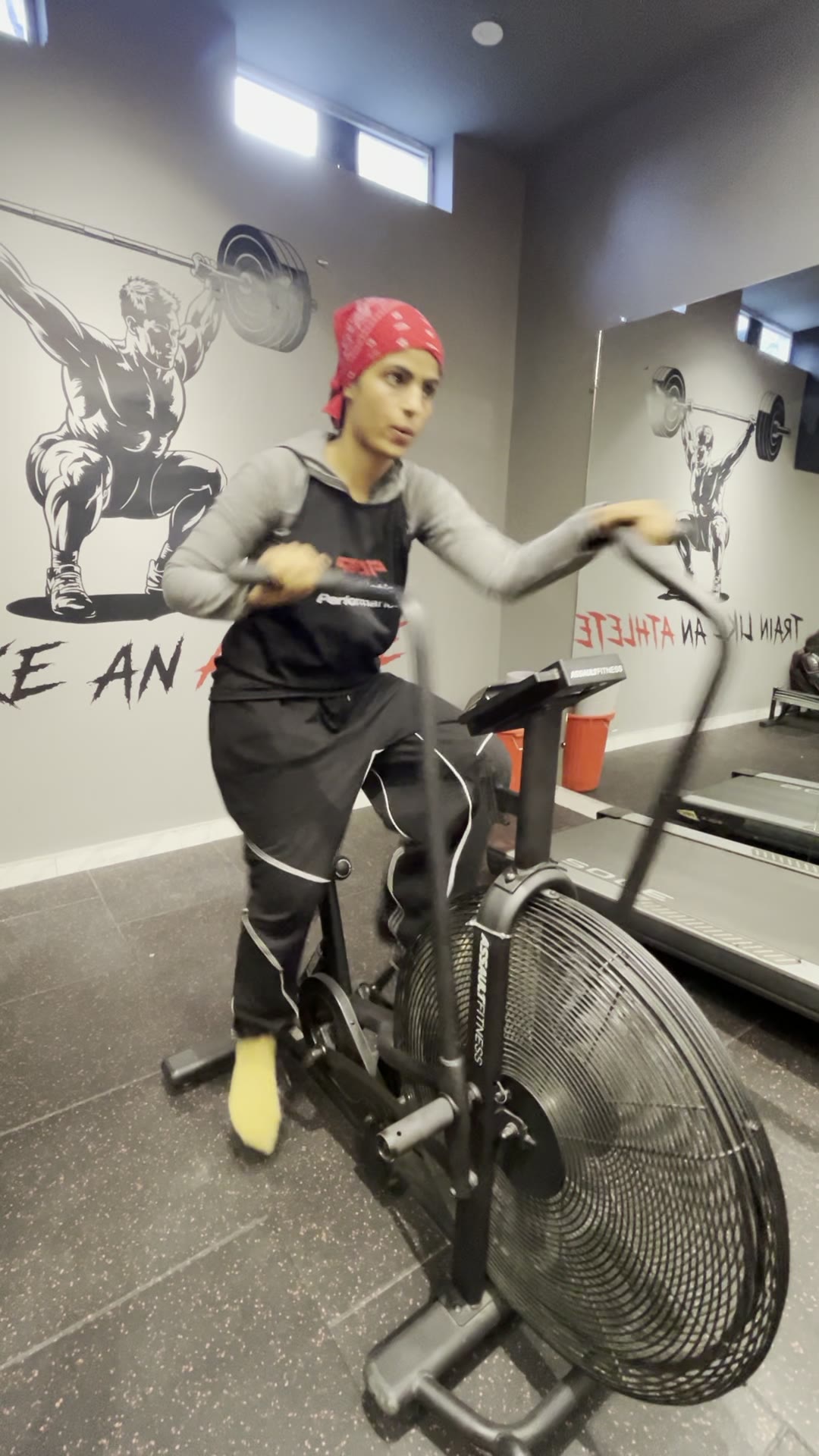 StrongHer member on the air bike at TAP DHA Phase 7